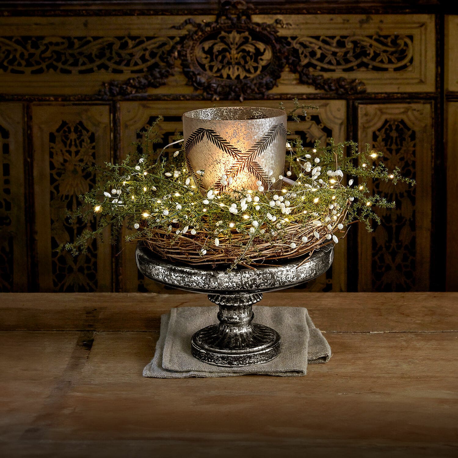 Etagere Incantesse Dekorativer silberner Metallkerzenhalter mit Weidenkranz und LED-Lichterkette auf Holztisch