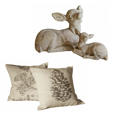 Dekoration mit zwei beigen Kissen mit Zapfen- und Blumenmotiv sowie einer Steinfigur von zwei Rehen