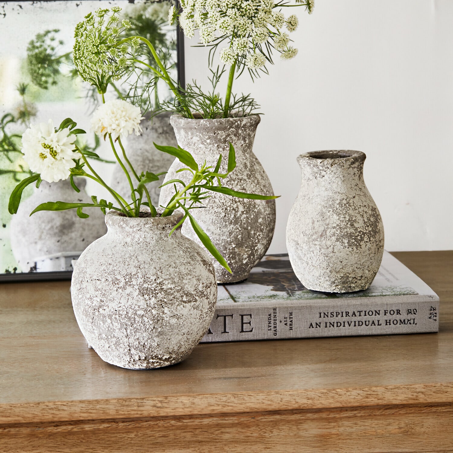 Vase 3er Set Cerquix Drei rustikale Steinvase in Grau-Weiss auf Holztisch mit weissen Blumen dekoriert