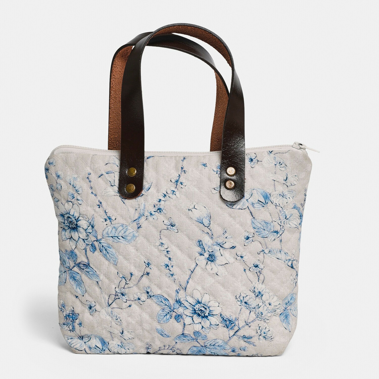Tasche Vailenne Beige gesteppte Tasche mit blauem Blumenmuster und schwarzen Ledergriffen, modisches Accessoire