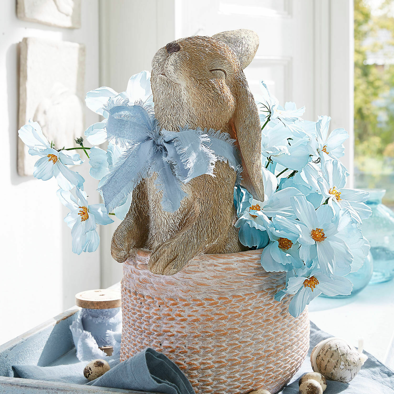 Deko-Blumenstrauss Tilla Dekorativer Stoffhase im Korb mit blauen Blumen und Schleife für Frühlingsdekoration