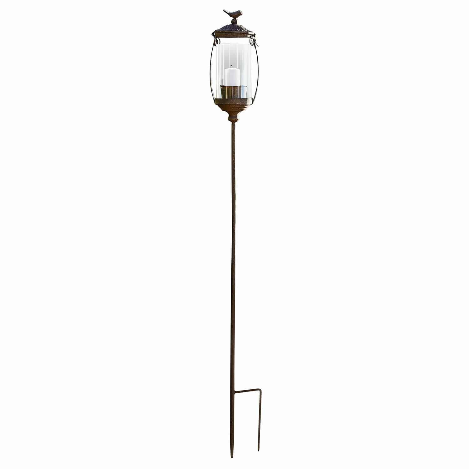Laterne Nexoril Dekorative Gartenlaterne aus braunem Metall mit klarem Glas und weisser Kerze auf Erdspies