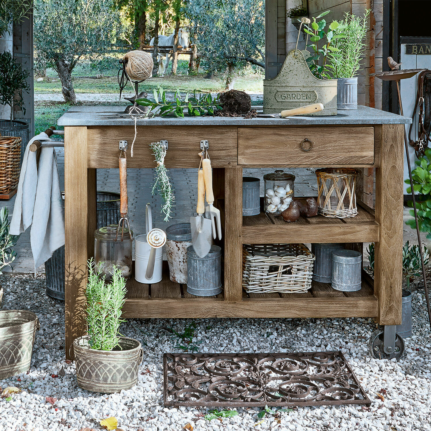 Pflanztisch Ellenton Gartentisch aus Holz mit Gartenwerkzeugen und Töpfen auf Kiesboden in natürlicher Umgebung