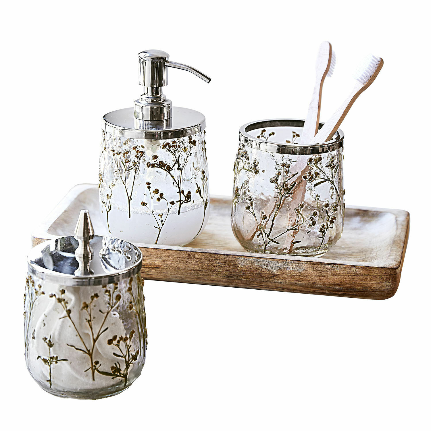 Bad-Set Elorisse Badezimmer-Set aus Glas mit getrockneten Blumenmotiven und Metallakzenten auf Holztablett.