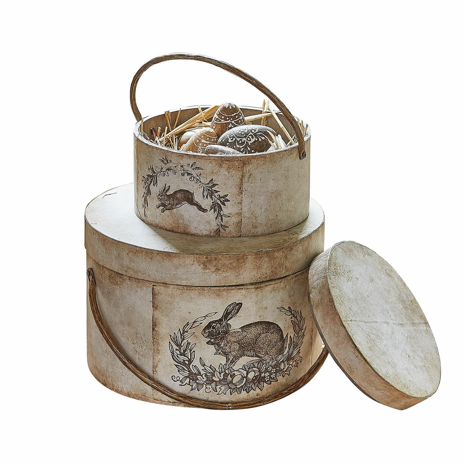 Box 2er Set Roxelle Runde Pappschachteln in Beige mit Hasenmotiv und dekorativen Ostereiern innen.