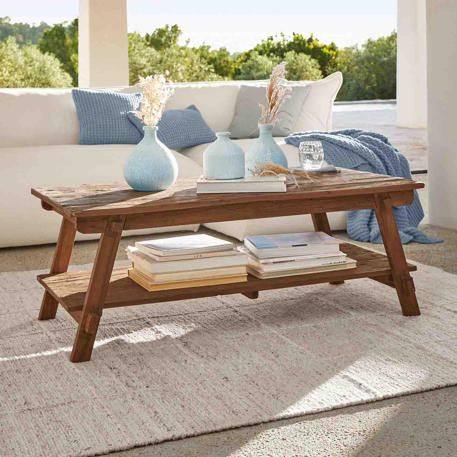 Brauner Couchtisch aus Akazienholz mit Ablage und blauen Dekovasen in hellem Raum