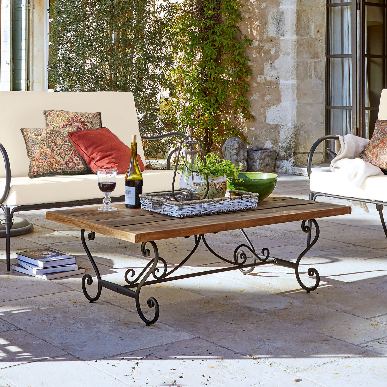 Tisch Fontaneda Couchtisch mit Holzplatte und geschwungenem Metallgestell im Vintage-Stil auf der Terrasse