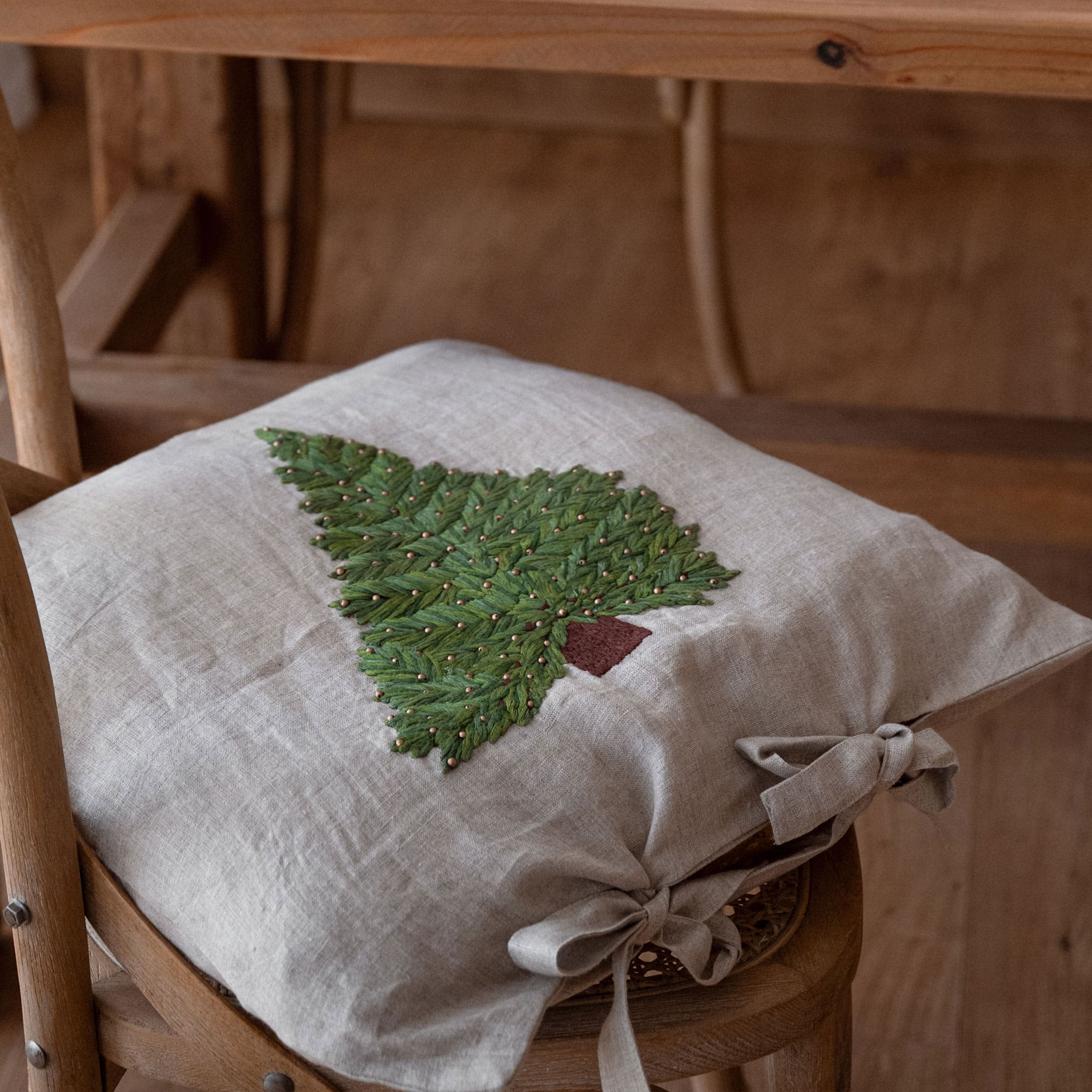 Leinen-Kissenbezug in Beige mit grünem Tannenbaum-Stick und Schleifen, Weihnachtsdekoration