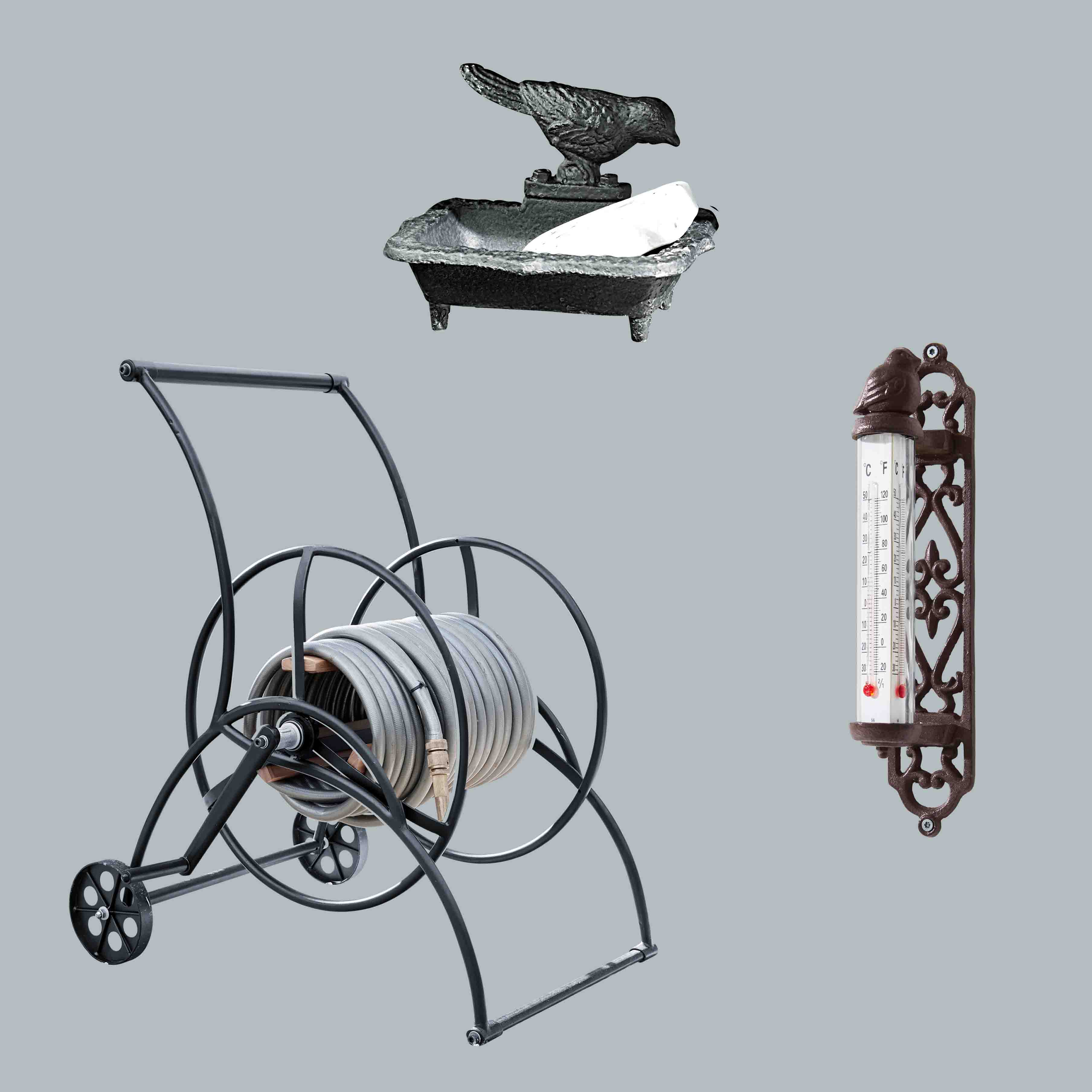 Metall-Gartenschlauchwagen mit grauem Schlauch, Gusseisen-Seifenschale und Vogel-Thermometer