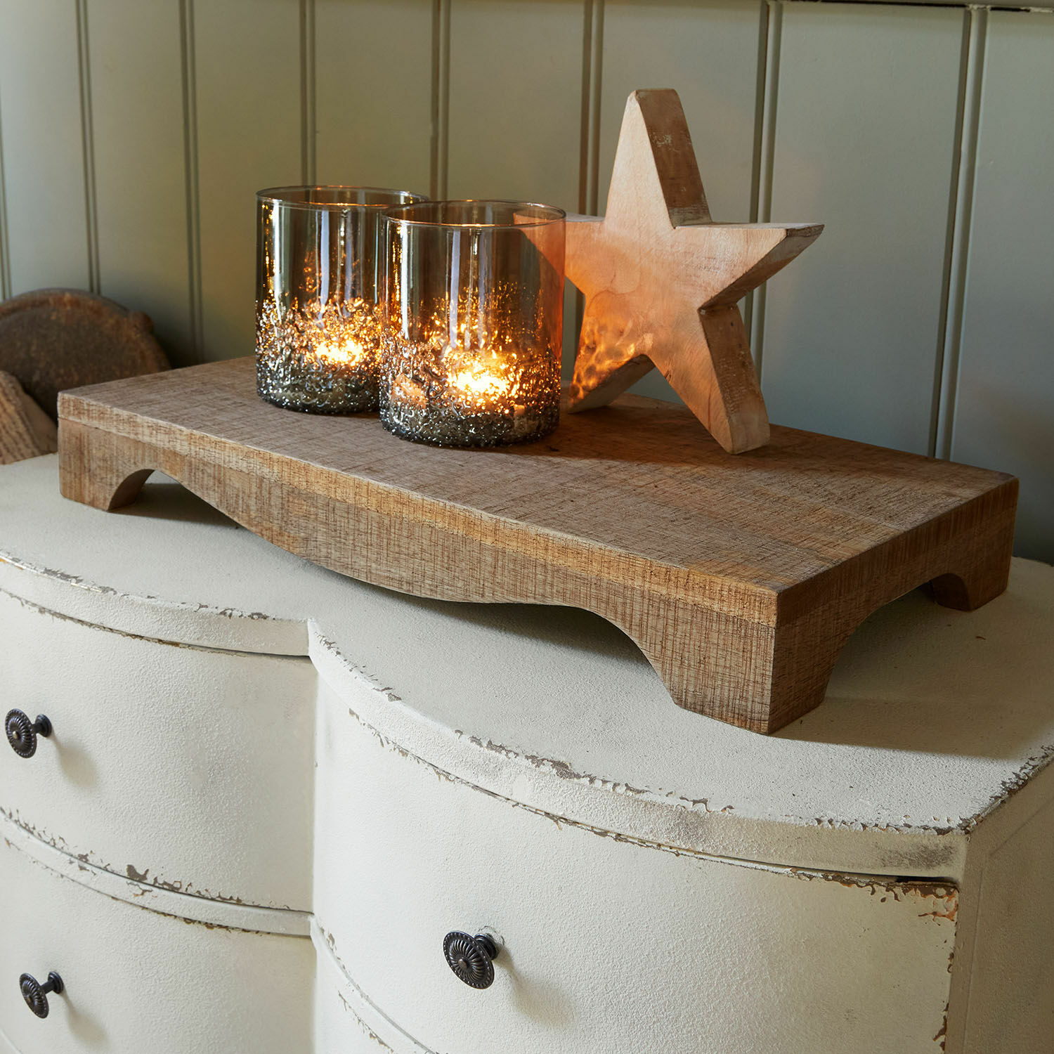 Tablett Torviano Holztablett mit zwei Glas-Kerzenhaltern und Holzstern auf weisser Shabby-Chic-Kommode