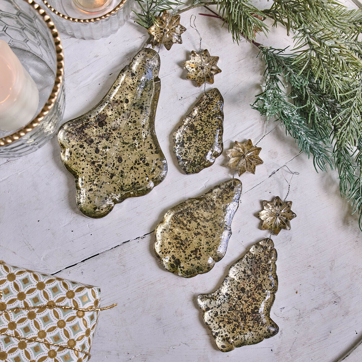 Weichnachtsschmuck 4er Set Dolenza Set goldfarbiger Metall-Weihnachtsanhänger in Glocken- und Sternform auf weissem Hintergrund