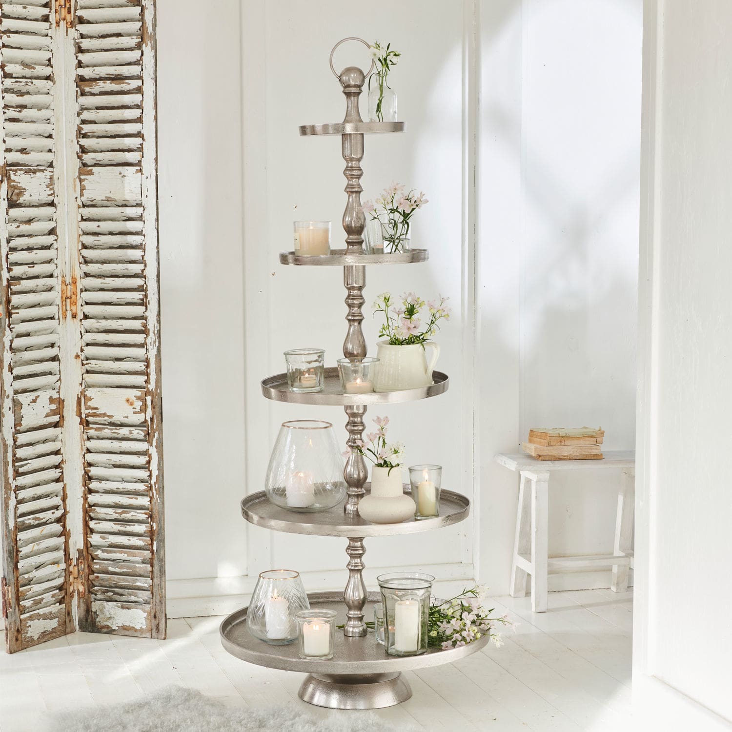 Etagere Magonie Fünfstöckige silberfarbene Metall-Etagere, dekoriert mit Kerzen und weissen Blumen