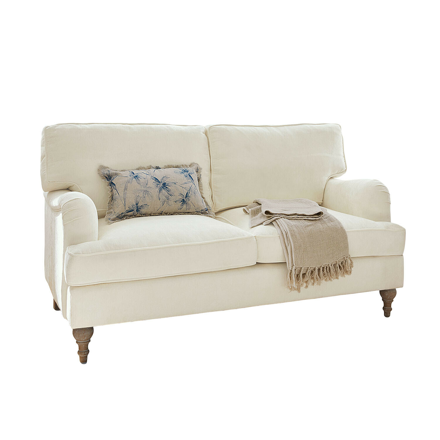 Sofa Elvika Beiges Stoffsofa mit floralem Kissen und beiger Decke auf gedrechselten Holzbeinen