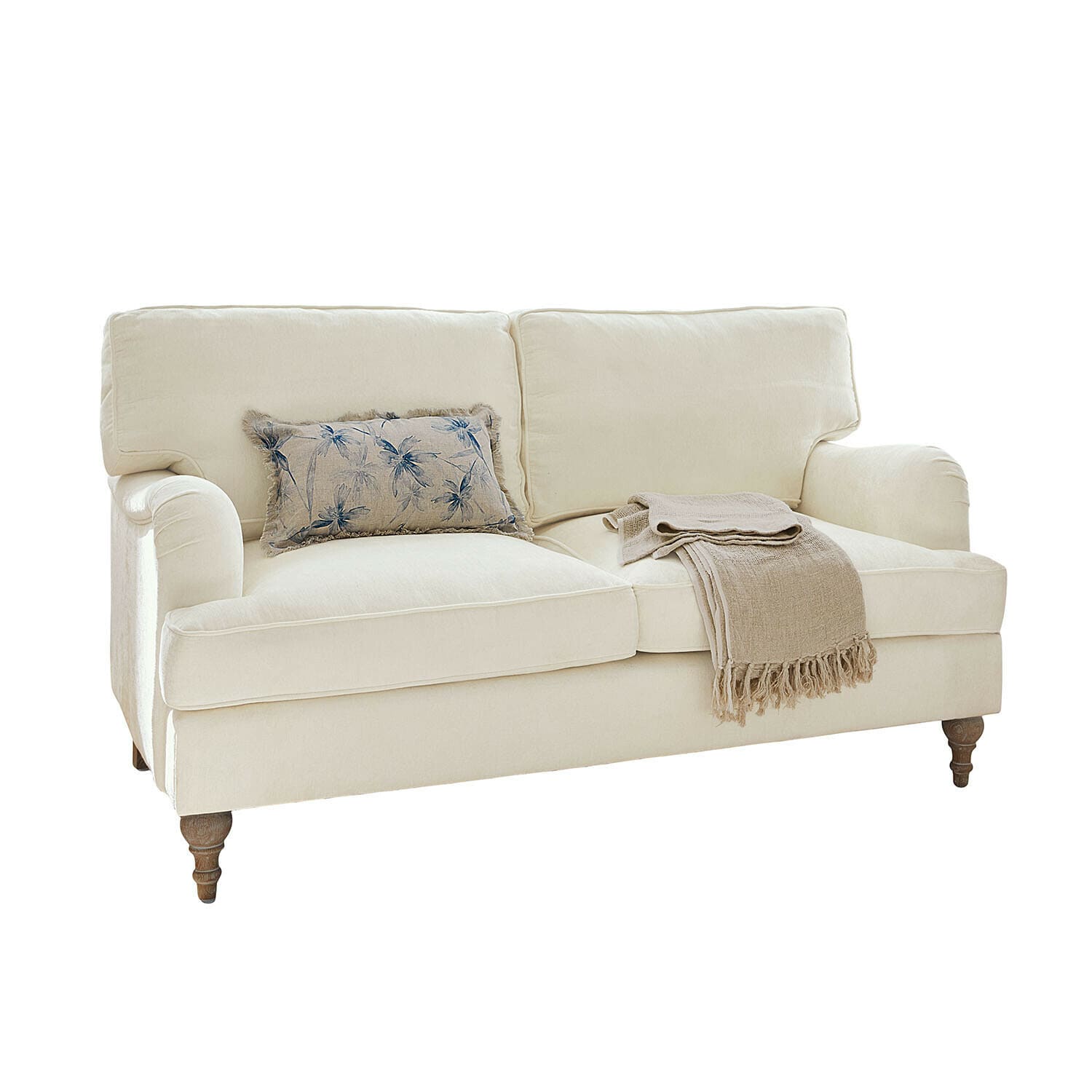 Sofa Elvika Beiges Stoffsofa mit floralem Kissen und beiger Decke auf gedrechselten Holzbeinen