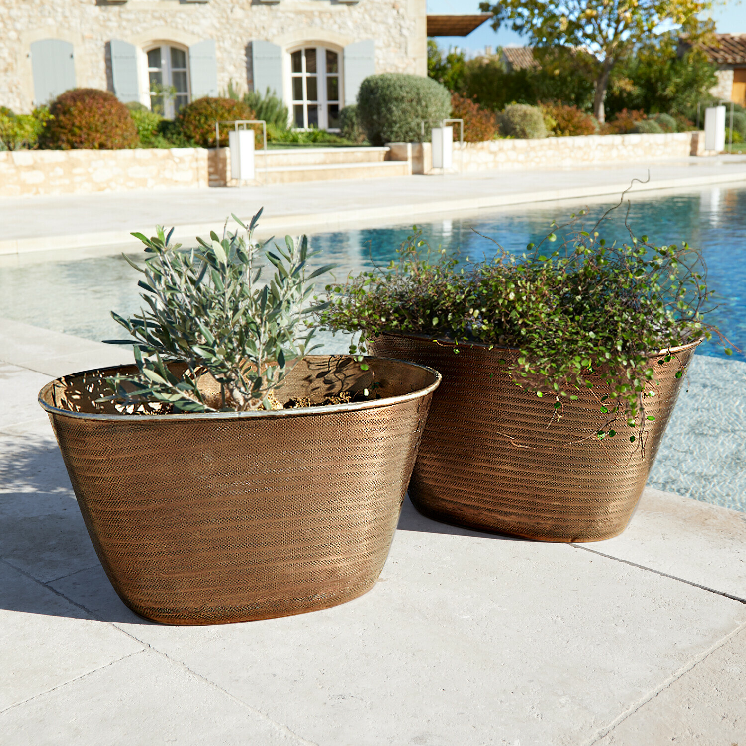 Übertopf 2er Set Rinalo Zwei kupferfarbene Pflanzkübel mit Pflanzen neben Pool auf steinerner Terrasse, Gartendekor