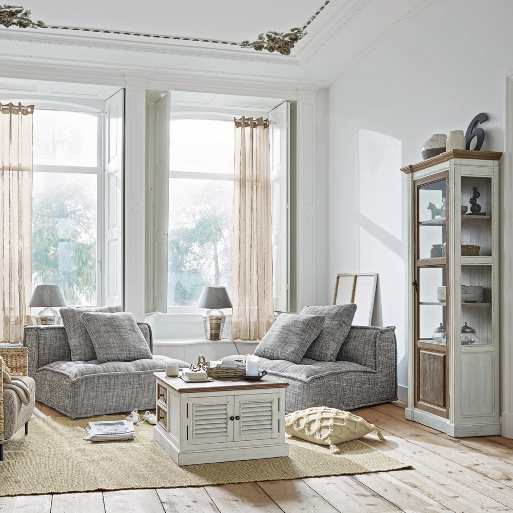 Helles Wohnzimmer mit grauen Sesseln und weissem Holzschrank auf Juteteppich, moderner skandinavischer Stil