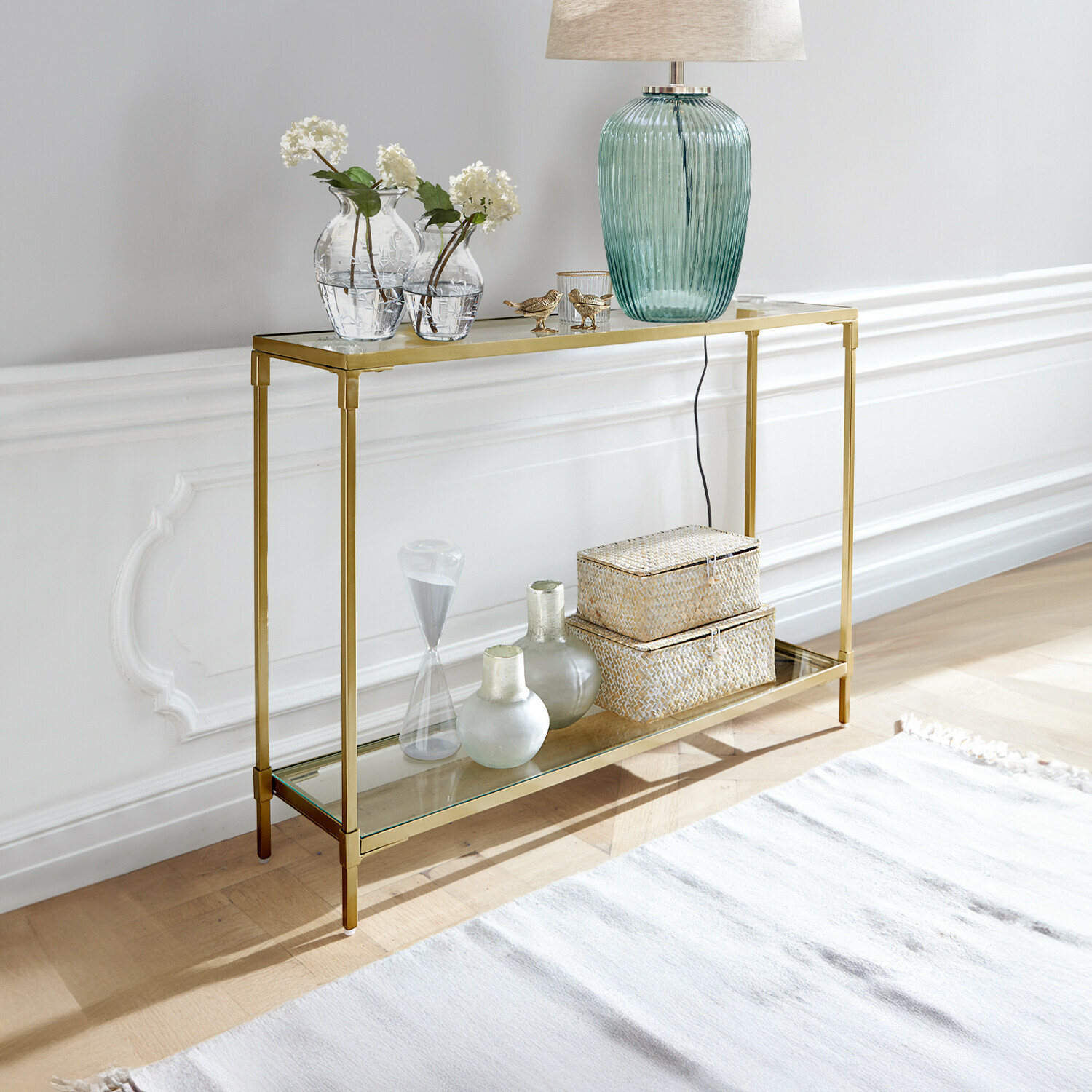 Konsole Ninove Goldfarbener Metallkonsolentisch mit zwei Glasablagen, dekoriert mit Lampe und Vasen, modernes Design