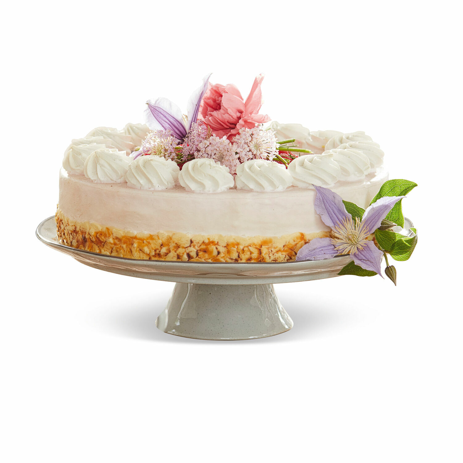 Platte Biarré Torte auf Keramikständer mit Creme und pastellfarbiger Blumendekoration