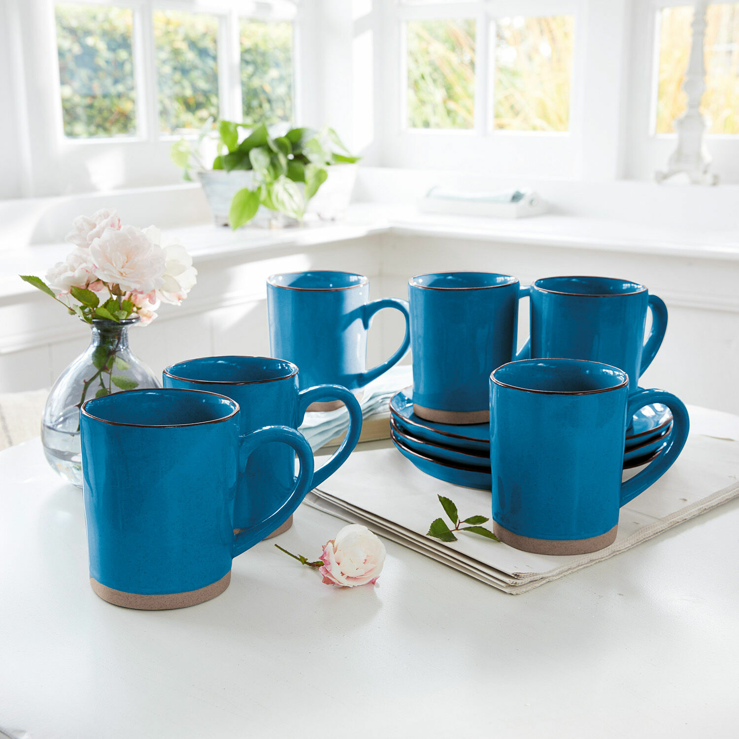 Tasse 6er Set Biarré Sechser-Set blaue Keramiktassen mit braunem Boden auf weissem Tisch in heller Küche