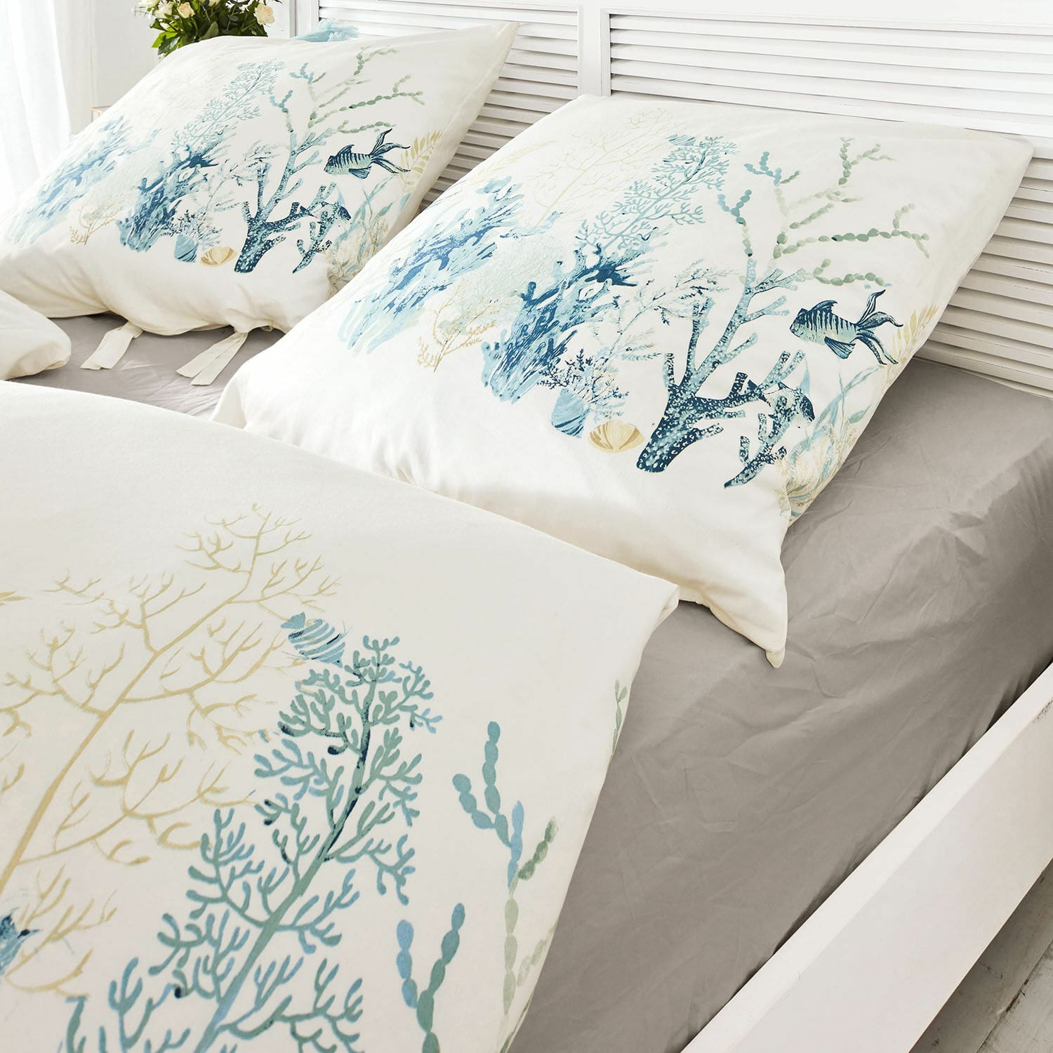 Bettwäsche Grosmagny Bettwäsche aus Baumwolle mit maritimen Motiven in Blau- und Beigetönen auf grauem Spannbettlaken.