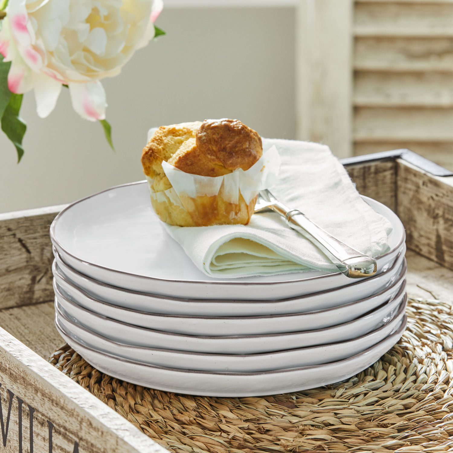 Dessertteller 6er Set Biarré Set aus weissen Keramiktellern mit Muffin und silbernem Messer auf Leinenserviette