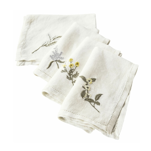 Weisse Leinenservietten mit floralen Stickereien, dekorativ und elegant für den Tisch