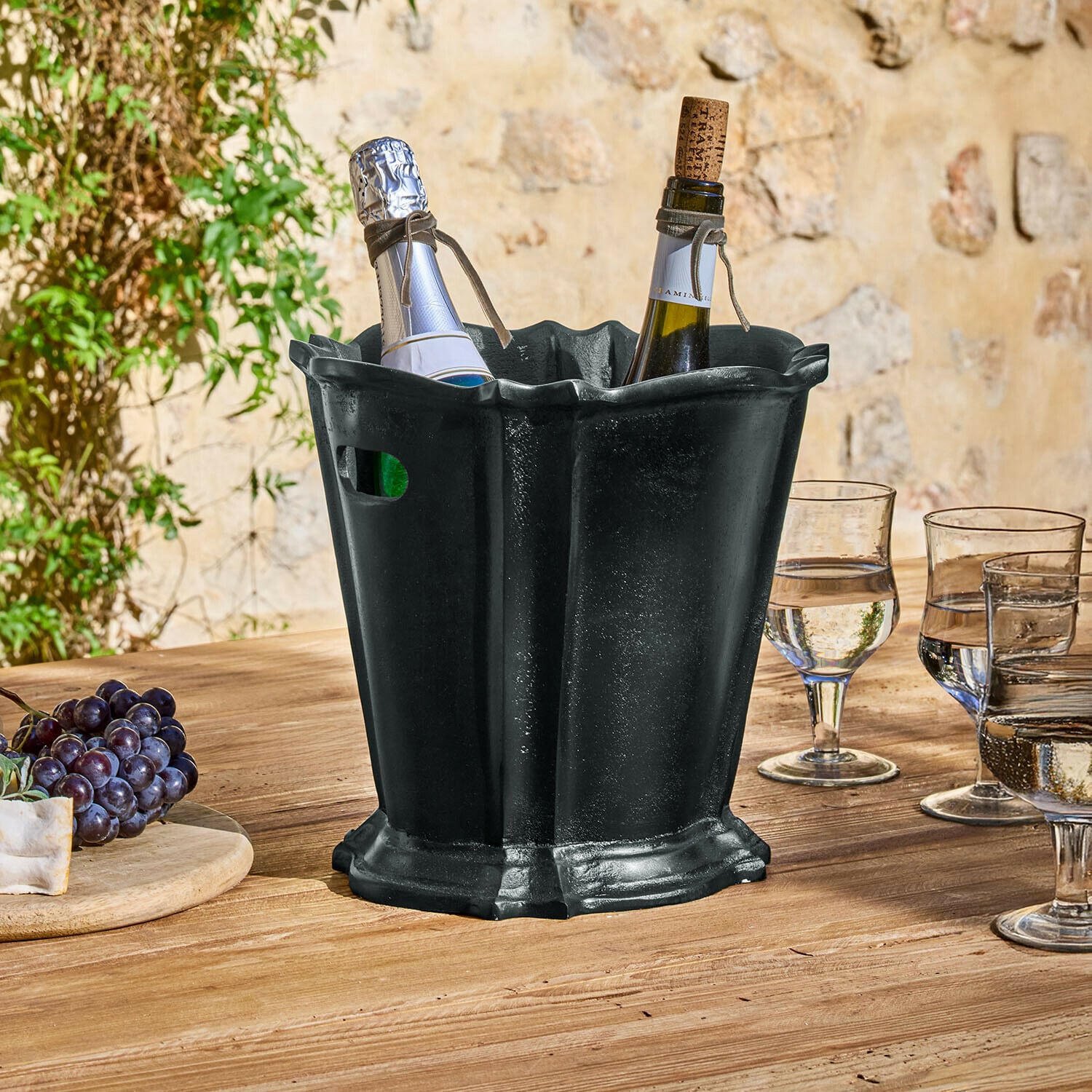Getränkekühler Trévaux Schwarzer Metall-Eiskübel mit zwei Weinflaschen auf Holztisch im Aussenbereich