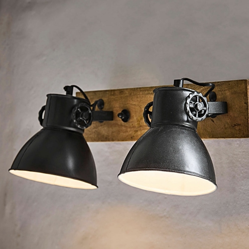 Schwarze Metall-Wandleuchte mit zwei Schirmen auf Holzplatte im Industriedesign